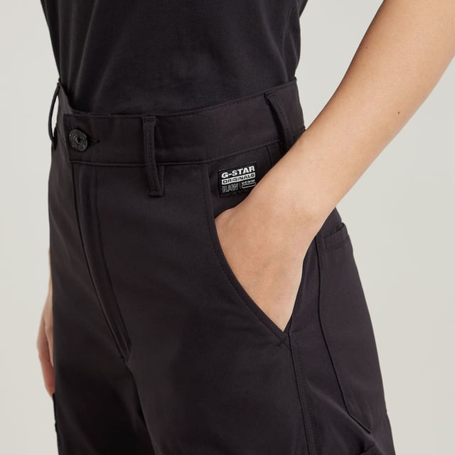 Zip fly. Inset pockets. Welt pockets at the back. Thigh pockets with additional flap pockets on top, snap buttons. Key ring at one of the thigh pockets. Zip & button closure. Ultra-high waist. Cargo pants High Waist are designed in a straight fit and offer an ultra-high waist. Pleats at the outer leg add more shape to this design. The pockets at the thigh show additional flap pockets on top. A key ring is added to one side. 65% Polyester (Recycled), 35% Elastomultiester. Comfortable stretch. Straight