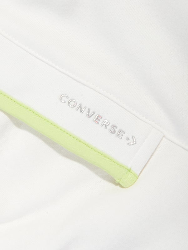 Converse combine 70s nostalgia with new innovative properties. This girls hoodie is reflective of the American label's preference for authentic streetwear. Crafted in a beautiful cotton blend via balloon effect long sleeves and a stitched neon front hidden Velcro pocket with Converse silver metallic detail adorned on the front. ‚Ä¢ Quarter Zip Fastening ‚Ä¢ Ribbed Trims ‚Ä¢ Neon Green Trims ‚Ä¢ 60% Cotton ‚Ä¢ 40% Polyester