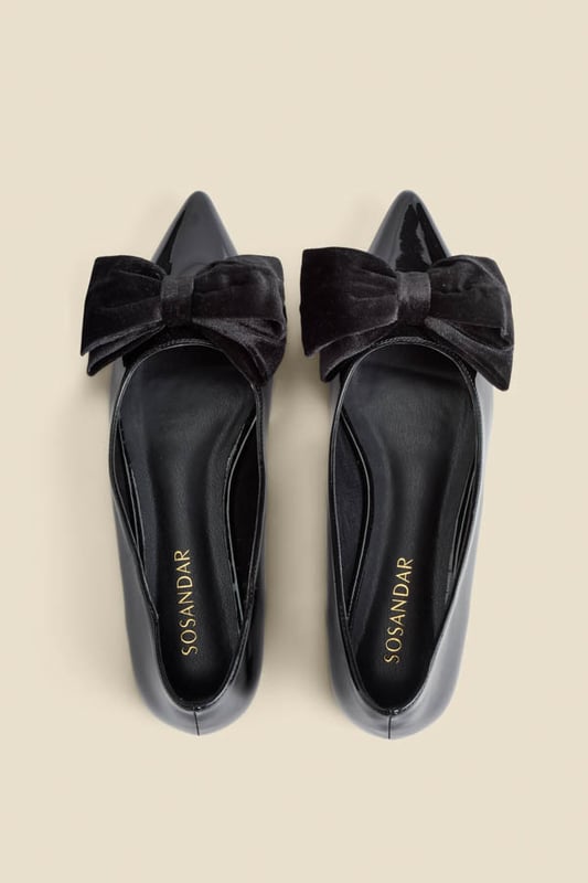 Who needs heels?Luxe patent leather for a hi-shine finish Adorned with a plush velvet bow Wear-forever pointed toe silhouette Flat sole so you can dance the night away We're styling them with wide-leg trousers and a sparkly top