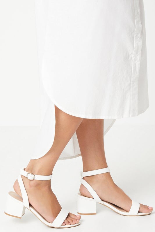 Wide fit design offers a comfortable and accommodating fit
Barely-there strappy silhouette with minimalist appeal
Mid block heel provides a modest lift and walkable height
Faux leather upper exudes a look and feel
Ankle strap with buckle closure ensures a secure fit

These versatile sandals are perfect for casual daytime outings or relaxed evening affairs. Pair them with a flowy midi dress or cropped trousers for a chic, on-trend look that transitions seamlessly from brunch with friends to an evening baby shower. The neutral hue complements a variety of ensembles, allowing you to showcase your personal style effortlessly.