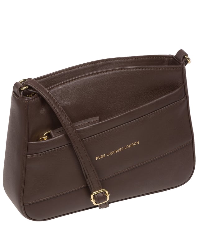 The 'Helena' cross body bag from the Pure Luxuries Marylebone collection is handcrafted from high-quality, genuine Nappa leather with a natural super-soft touch. The zip-over top opens to reveal a 100% cotton-lined interior. The spacious compartment features two slip pockets to help maintain an organised bag. A zipped pocket on the front of the bag provides on-the-go storage. Features gold-coloured metal fittings and zips alongside the adjustable slim leather strap, with a maximum drop length of 65cm. The Pure Luxuries logo is embossed in gold foil for a beautifully simple finishing touch.