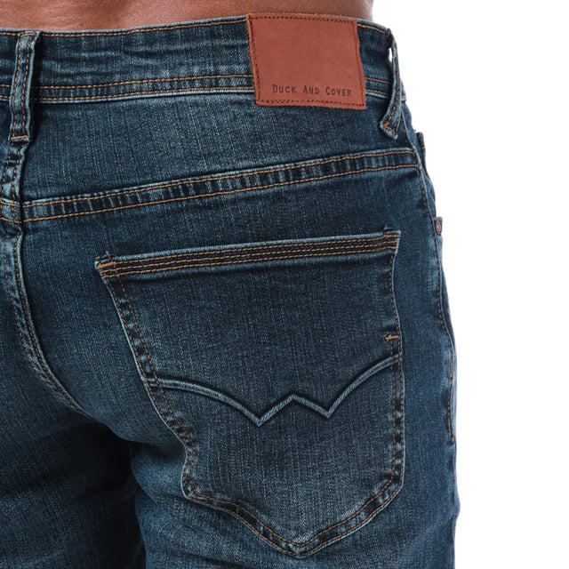 Mens Duck and Cover Overbug Dark Wash Tapered Jeans in Denim- Dark wash- Zip fly- 5 pocket design- Contrast stitching- Tapered design- Branding to reverse waist and front pocket-Short inside leg length approx. 30 inch  Regular inside leg length approx. 32 inch  Long inside leg length approx. 34 inch.  - 72% Cotton  26% Polyester  2% Elastane. Machine Washable- Ref: DC2B111736Measurements are intended for guidance only