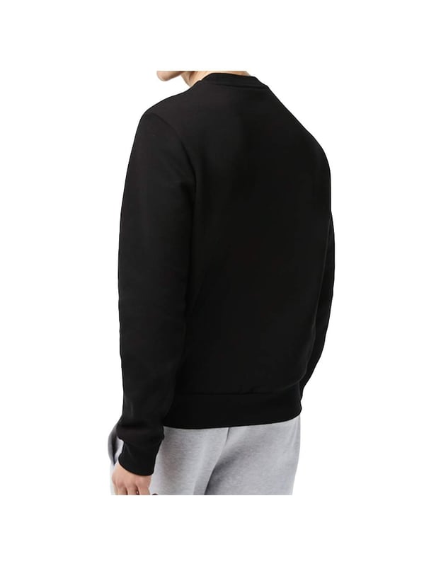 Solid-colored sweater with a round neckline, ribbed cuffs and subtle logo patches in a regular fit.