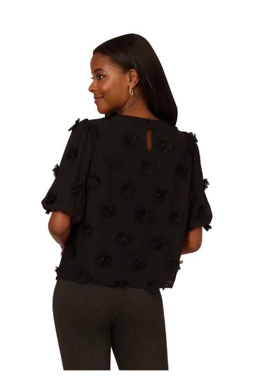 Add a fun dimensional moment to your outfit with this cute short sleeve top dotted with fluttery chiffon flower appliques. Balloon sleeves hit just above the elbow to complete the sweet, romantic feel of this blouse. A keyhole button closure at the back finishes the crew neck collar. Perfect for work and weekend style, you will love the way this charming top dresses up any look.