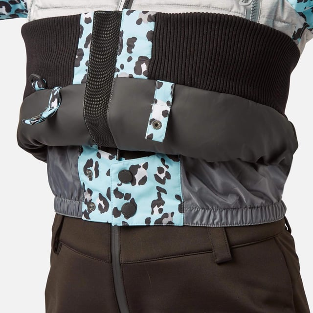 The Surfanic Fiore ski and snowboard jacket is a popular street-styled high-performance mountain jacket for all occasions. Classic feminine design with premium warmth, this low loft puffer jacket is filled with 100% recycled insulation that warms up as quickly as it dries out, for all-day comfort. This street-styled block gives you the right mix of form and function.

The Surftex 10K outer shell provides excellent waterproof protection from the winter elements, while the 10K breathability rating allows body heat and moisture to escape through the fabric for optimum comfort throughout the day. The jacket's shell fabric has a high-performance durable coating with taped seam construction that offers exceptional heat retention in cold conditions and a high level of breathability that ensures excess heat doesn't form into condensation on the inside of the jacket.

The detachable hood has a 3-way volume adjuster for increased all-round visibility when you are flying down the mountain and require the added protection of having your hood up and when the weather offers you a challenging day. The water-resistant front zipper has an internal reinforced storm flap for increased comfort and protection.

Powder skirt - Whether you're hitting the powder on skis or snowboard, this snow skirt creates a tight seal around your waist to keep the snow out and the warmth in. Made from durable waterproof materials and an internal dry butt patch (DBP) to keep it all warm and dry.

Snow cuff / wrist gaiter - This is perfect for even the most extreme conditions, featuring a tight seal that bridges the gap between your glove and jacket.

Zipped pockets - Pockets designed for everything plus a few more just in case. Pockets for goggles, lift pass, media, stash pocket for cash, wallet pocket and inside phone pocket for protection and to keep the battery warm and dry. Plus a detachable goggle wipe for those days when visibility is at a premium.

Design features:

    Detachable fur
    3-way volume adjusting hood
    Super soft chin guard
    Zipped sleeve ski pass pocket
    Snow cuffs with thumb loop
    Media pocket
    Goggle pocket
    Mesh-lined pit zips
    Detachable goggle wipe
    Twin zipped tricot lined hand warmer pockets
    Reinforced internal storm flap
    Waterproof snow skirt
    Dry butt patch (DBP)

Fabric & performance:

    Bomber fit
    Shell 100% polyester
    Water resistant coating 10,000mm
    Breathbility rating MVP 10,000 gm²

Insulation & lining:

    100% recycled polyester low loft insulation.
    Insulation. 80 gm² body 40 gm² Sleeves
    Lining 100% recycled embossed polyester.