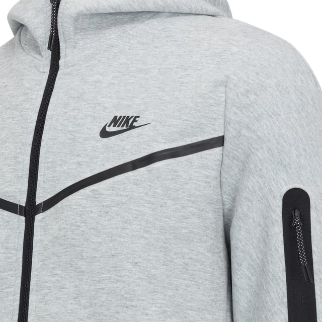 Nike Sportswear Tech Fleece Full Zip Tracksuit Grey Upgrade your wardrobe with the Nike Sportswear Tech Fleece Tracksuit Set, designed for modern comfort and style. Featuring the iconic Tech Fleece Full-Zip Hoodie and Tapered Joggers, this set offers premium warmth without the bulk, making it an essential choice for everyday wear and casual outings.
Key Features:
Tech Fleece Fabric: Engineered with lightweight, double-sided fabric for superior insulation and a sleek, streamlined appearance.
Full-Zip Hoodie:
Panelled hood for enhanced coverage and warmth.
Split kangaroo pockets for convenient storage.
Durable, bonded zipper with a smooth glide and signature tape detailing.
Tapered Joggers:
Tapered fit with ribbed cuffs for a clean, modern silhouette.
Zippered side pocket with bonded trim for secure storage of small essentials.
Elastic waistband with an adjustable drawcord for a personalised fit.
Composition:
Body: 66% Cotton / 34% Polyester
Pocket Bag Palm Side: 69% Cotton / 31% Polyester
Pocket Bag Knuckle Side: 100% Cotton
Why You’ll Love It:
The Nike Sportswear Tech Fleece Tracksuit Set is designed to keep you warm while maintaining a lightweight feel. The hoodie’s structured hood and sleek zipper details complement the joggers' tapered leg for a streamlined, stylish finish. Whether you're on the go or relaxing, this tracksuit offers the perfect combination of functionality and fashion.
Pair it with your favourite Nike sneakers for an effortlessly cool look.