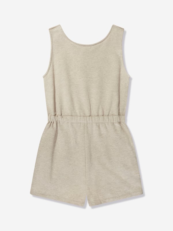 Chloé Girls Sleeveless Playsuit in Beige Chloé portray demure whimsical subjects in their exquisite aesthetics. This girls sleeveless jumpsuit is depicted in unbrushed fleece cotton via lacing at the front, golden trims, large embroidery Chloé on the chest, elasticated waist and piped pockets. She will look and feel divine. 100% Organic Cotton Sustainable