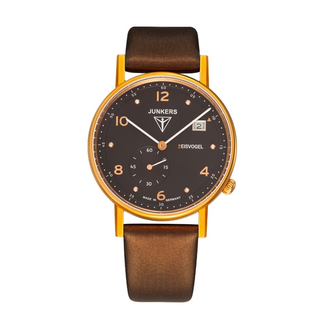 Manufacturer: POINT tec GmbH, Ismanning
A women's watch from the new Eisvogel F13 series with a quartz movement (Ronda 6004.D, Swiss Made, 5 jewels) and a grained dial with rose gold numbers.

General
Functions: small seconds, date
Model series: Junkers F13 Lady
color: brown
Special features: indices with 6 crystals, made by Swarovski
Water resistance: 5 atm
Battery type: 373
Housing
Glass: mineral glass
Case material: stainless steel
Case color: rose gold
Plating: rose gold
height and weight
Weight: 36g
Walking diameter: 36 mm
Case Height: 7mm
clockwork
Movement Type: Quartz
Movement caliber: Ronda 6004.D
Stones: 5
Factory Note: Swiss Made
dial
Dial color: brown
bracelet
Bridge width: 18 mm
Strap color: brown
Strap material: leather