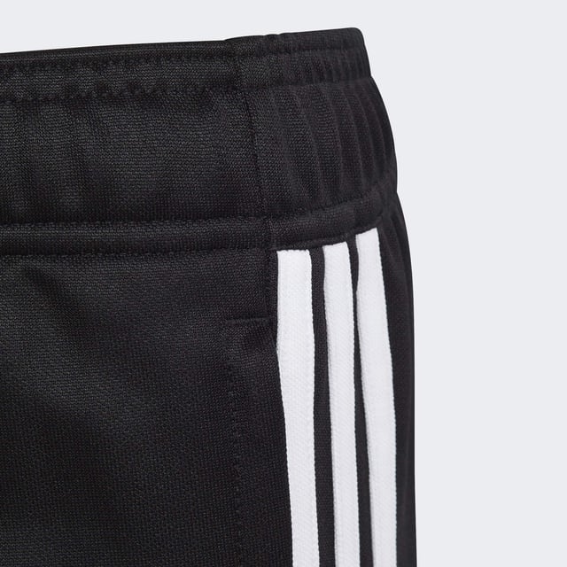 Essential training gear from adidas. Before you hit the pitch for that chilly winter session, layer up in these juniors' Tiro 23 Club football pants. Their slim, streamlined fit and moisture-absorbing AEROREADY will keep you flying through sprints and rondos. Once you reach perfect temperature, ankle zips make pulling them off over your boots a breeze.Made with 100% recycled materials, this product represents just one of adidas' solutions to help end plastic waste.  - Slim fit - Mid-rise elastic waist with drawcord - 100% polyester (recycled) - AEROREADY - Front zip pockets - Ankle zips  Shipped by adidas