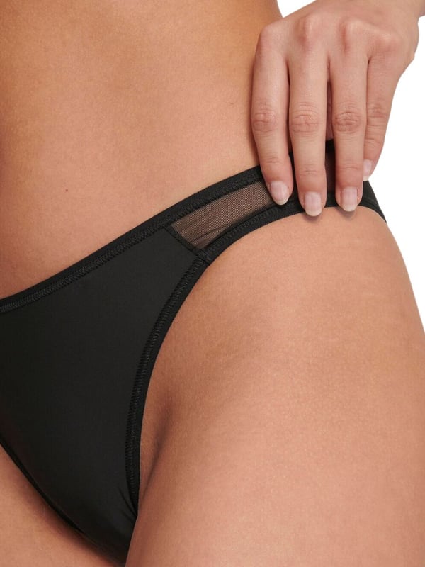Sloggi Soft ADAPT Tiny Tanga Briefs. Tanga style briefs with super-soft microfibre fabric and sheer mesh panel detailing. This product is recommended as hand wash only.