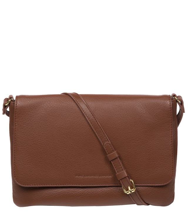 This stylish, sleek and spacious cross body bag from Pure Luxuries London's Marylebone Collection is a gem of a bag. The 'Ruby' features a fold-over top secured with a magnetic press-stud opens to reveal a 100% cotton lined interior and features three slip pockets concealed - ideal for all your essentials. The accessory is adorned with a slim and adjustable leather strap with a drop leather of 65cm. The design is finished with attractive gold-coloured metal fittings and zips which are a luxurious addition alongside the blind embossed Pure Luxuries logo which is a sophisticated finishing touch