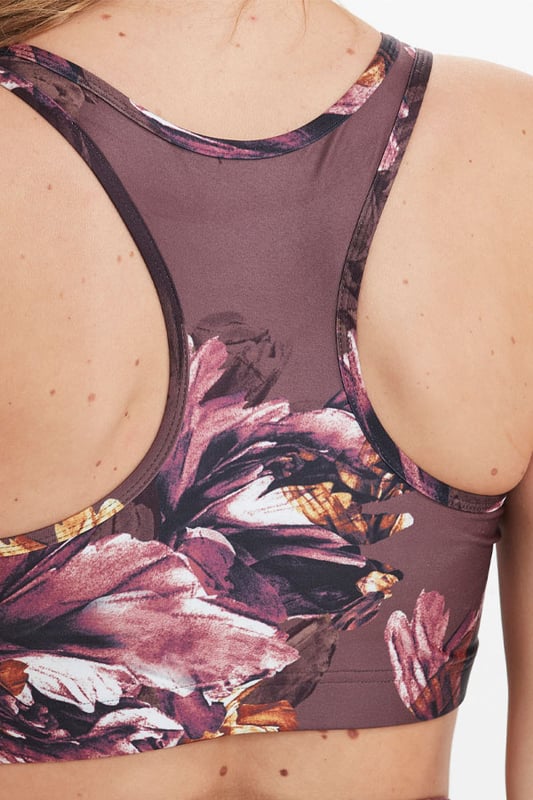 REASONS TO BUY:Â Almost too pretty to work out inGorgeous floral printHigh impact  high supportSexy racer backComfy sweat-wicking fabricMake a statement with the matching leggings
