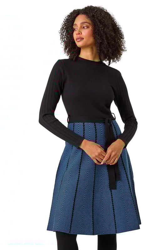 Chevron Print Belted Jumper Dress from Roman. Upgrade your daytime wardrobe with this elegant knee-length, knitted dress. Cut from a soft knitted fabric this dress features a modest round neckline and cosy full-length sleeves. A printed, panelled contrast skirt falls to a fun knee-length in a flattering fit and flare style. A self-tie fabric belt adds shape at the waist if desired while its pull-on style makes for quick and easy dressing. Pair with tights, boots and a fluffy gilet for a cute and casual everyday style!