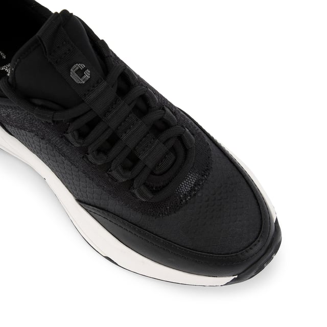 This Swift Runner trainer features a black snake embossed upper with lace up front. There is a gunmetal Icon C stud on the tongue tab and a matching gunmetal panel at the heel.