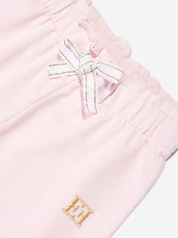 German heritage luxury label Escada combine modern innovation with timeless elegance. This girls bright white t-shirt is a captivating construction. Envisioned in refined cotton with an elasticated gold glitter waistband and Escada printing. Made for comfort and style, she will be obsessed. Straight Hem  Escada Print Down Bottom Left Leg 95% Cotton, 5% Elastane