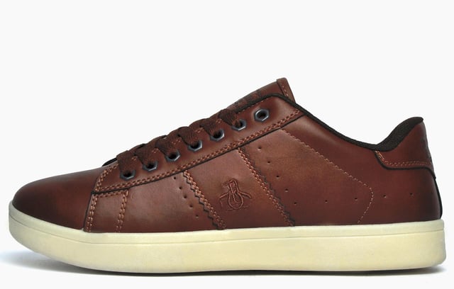 Tap into sleek, contemporary casual style with these Steadman designer trainers from iconic menswear brand, Original Penguin. The Penguin Steadman is a sleek and refined everyday trainer thats packed full of authentic American retro styling. Bringing heritage inspired style to your casual outfits, the Penguin Steadman is a versatile choice for the new season. Crafted from a synthetic leather-look upper and featuring intricate stitch and panelled detailing to the sides, and finished with Penguin branding to the tongue, side and heel, this is a must have trainer for any stylish man looking to elevate his casual look.
 - Synthetic upper
 - Memory foam sockliner
 - Textured wrap around outsole
 - Intricate designer stitch detailing
 - Panelled trims and overlays
 - Sumptuous memory foam footbed
 - Classic lace up fastening
 - Original Penguin branding throughout