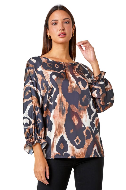 Abstract Print Blouson Sleeve Top from Roman. Elevate your casual collection this season with this luxurious woven top. Bringing a glamorous energy to your daytime style, this top is adorned in an abstract print that's filled with Autumnal hues making it perfect for the upcoming season. Designed with a round neckline which features a playful keyhole cut-out and full-length blouson sleeves that ooze feminine energy. Wear with smart trousers and heels for the perfect desk-to-dinner style.