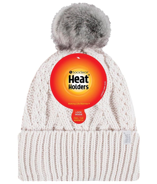 Like the original Heat Holders ladies pom pom but with a modern styled knit, this Solna styled hat like the original aims to keep you cosy and warm whilst keeping you fashionable with their contemporary style and knit. These womens pom pom hats have a fleece plush insulation lining, called Heatweaver, that is even more effective at holding warm air than any regular lining. This thermal lining is designed to be soft with a luxurious fleece feel (it almost feels like your touching the golden fleece) whilst holding warm air close to your skin, effectively keeping the cold air out. All of this is designed to ensure that you are toasty warm throughout the cold weather. This pom pom hat has a turn over cuff and a large faux fur fluffy pom pom on the top of the hat. This hat has a cable knit construction on its outer to give a fashionable touch. These ladies Solna hats are also to be considered the most slouch like out of all of Heat Holders’ range of thermal hats. These ladies Heat Holders Solna styled pom pom hats are available in 7 colours including cream, denim and light grey. They are made from 55% Polyester, 45% Acrylic on the outside of the hat and the lining is made from 100% Polyester. They come in one size and they are machine washable.