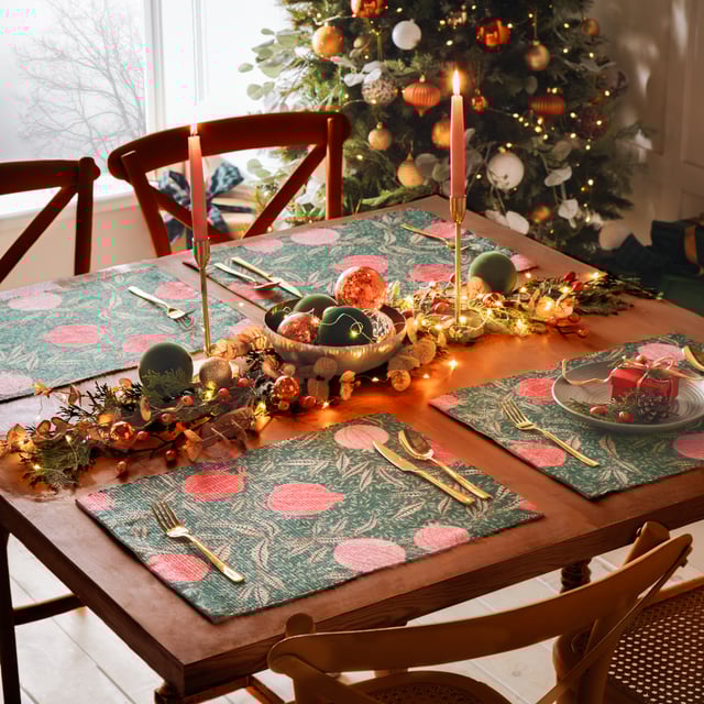 Displayed in all its glory, the Pomegranate set of four placemats is the perfect addition to your home this festive period. Digitally printed for exceptional clarity on a durable woven polyester fabric, the opulent, juicy fruits intertwine with gold leaves, complimenting the warming green background. A refreshing alternative to traditional festive decor, this beautiful set brings richness to the Christmas dining table and will look fantastic all year-round.
