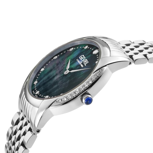 Gevril Airolo - Diamond
Gevril’s simply stunning Airolo collection is the elegant epitome of minimalist approach creating maximalist effect. With a carefully crafted design that lets the art of subtlety speak for itself, Airolo is a diamond-forward class act.

The Airolo Collection, Gevril Women's Swiss Diamond Watch, gathers inspiration from the breathtaking resort town deep in the Swiss Alps where the heart of three valleys meets. This stunner takes the best of all its influences: solid craftsmanship, style and romance create an impactful timepiece for the ages.

With a 36mm round stainless steel, polished case, brilliant mother of pearl dial, Airolo radiantly features 12 diamonds as time indices. The diamonds don’t end there… in three equally winning options, Airolo has a clean, stainless-steel bezel, a half diamond bezel with over half of a carat of 34 diamonds or a full diamond bezel with close to a carat of 56 diamonds. All with expert clarity and color. A push pull crown with blue cabochon stone adds one final detail to the already alluring watch that comes with either a genuine Italian Pearl Finished leather strap or a stainless-steel bracelet. You simply cannot go wrong.

Gevril’s Airolo collection is effectively sleek and chic, a feat for a diamond dazzler. No matter the option, a timepiece like Airolo is timeless.

Gevril 13147B Airolo Swiss Quartz Diamond Watch

Gevril Women's Swiss Quartz Diamond Watch from the Airolo Collection
36mm Round SS Polished Case, White MOP Dial
56 Diamonds on case 0.92 TCW, 12 Diamonds on Dial 0.2 TCW, Clarity VS, Color FG
Push Pull crown with Blue Cabochon Stone
SS Screw in case back, Limited Edition 01/500
316L Stainless Steel Bracelet with Deployment Buckle
Anti-reflective Sapphire Crystal
5 ATM (50 Meters 165 Feet)
Swiss Quartz Movement Ronda 762