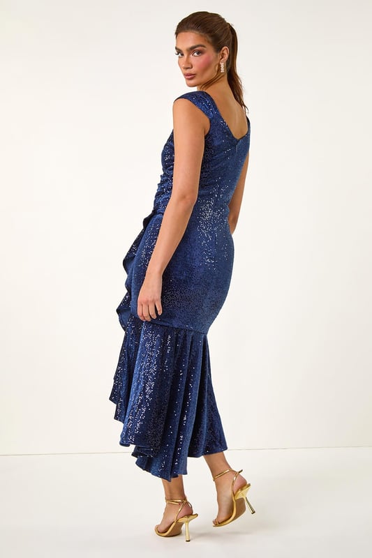 Sequin Velvet Bardot Stretch Midi Dress from Roman. Get ready to dazzle in our stunning velvet midi dress, perfect for any special occasion. The flattering bardot neckline and sleeves feature stunning velvet and sequin details, making this dress an elegant choice. Crafted from stretch woven fabric and lined for comfort, this dress falls to a midi length with a highlow hem for added flair. Finish off your look with heels and a bolero for a show-stopping look guaranteed to turn heads!