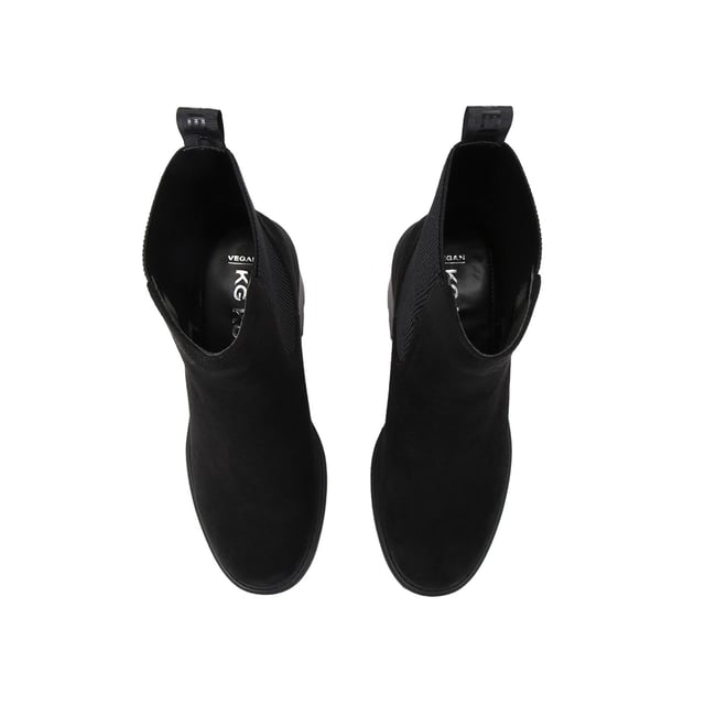 The KG Kurt Geiger Turin boot features a black microsuede upper with elasticated panels at the sides. There is a KG Kurt Geiger branded tab at the back of the ankle for slip on ability. Heel height: 7cm.