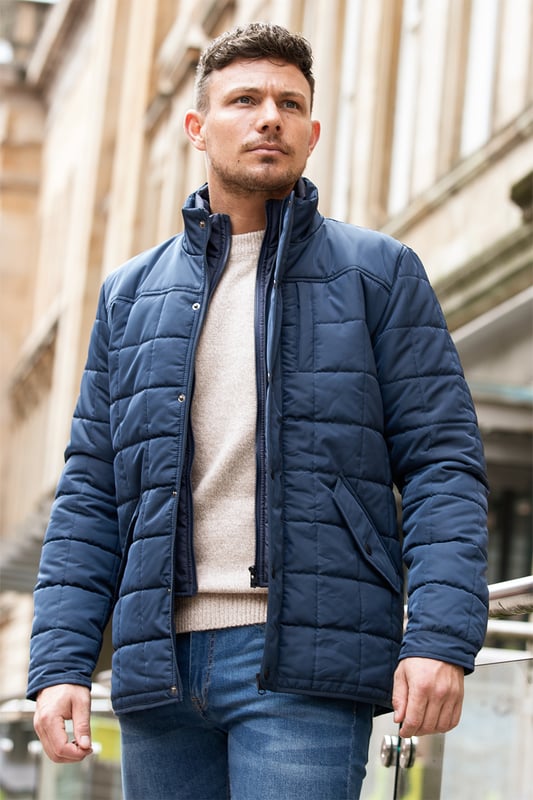 Stay warm and stylish with this square-style padded jacket from Kensington Eastside, featuring a button and zip-up fastening for ultimate comfort. With a funnel neck and two front pockets, this jacket is perfect for keeping your essentials close by. Ideal for outdoor adventures or casual wear, it's a must-have addition to your wardrobe this season.