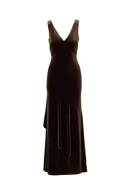 Elegant details elevate this velvet mermaid gown for the season. This formal dress features a sleeveless bodice, v-neckline, is fitted through the body, and contrasted by a mermaid skirt with a ruffled hem. Designed with a soft yet shining velvet fabric, this mermaid gown is elevated by a cowl back with a zipper closure at the centre back. Styled with nude high heels and a beaded clutch, this sleeveless velvet gown
