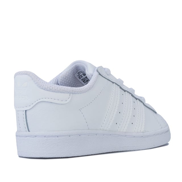 Infant adidas Originals Superstar Trainers in footwear White. – Smooth coated leather upper. – Elasticated lace closure for easy on-off. – Classic rubber shell toe. – Padded collar and tongue. – Tonal 3-Stripes to sides and printed ‘Superstar’ wordmark. – Tonal print Trefoil branding to tongue. – Tonal heel patch with embossed Trefoil logo. – Comfortable textile lining. – Removable Ortholite sockliner for comfort and odour control. – Herringbone-pattern rubber cupsole. – Includes set of regular laces. – Leather and synthetic upper – Textile lining – Synthetic sole. – Ref: EF5397