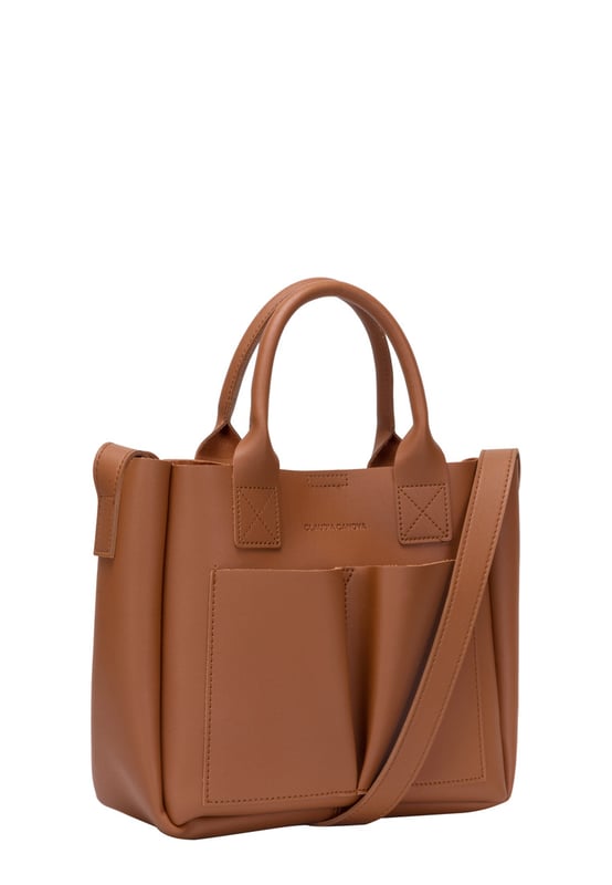 This dreamy mini grab bag is perfect for adding a contemporary look to your outfit. The soft PU exterior and contrast unlined interior gives it a premium finish and the gunmetal hardware adds quality. The subtle Claudia Canova blind debossed logo and intricate stitch detail finishes the look. Inside is a secure zip top pouch, which can be removed by unfastening the snap clasp buttons, perfect to use as a portable makeup bag or to keep valuable items more secure. Features: , soft pu outer, Unlined Interior, Claudia and Canova Blind Deboss Logo, 2 x Short Grab / Tote Handles, Adjustable longer shoulder strap, Magnetic snap claps opening to the main compartment, Removable zip top pouch (Meausure 215W x 152H x 50D), 2 x Quick access slip pockets in front Style Ref: 84608 TAN