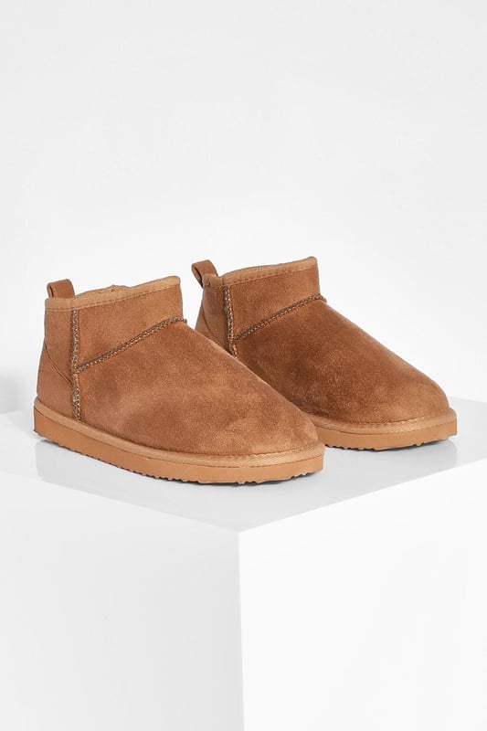 Ultra mini design for a contemporary twist on classic boot styles
        Flat heel between 0 and 2cm for all-day comfort
        Synthetic suede upper for a soft, luxurious feel
        Slip-on style for effortless wear
        Versatile silhouette suitable for various casual occasions
    
    Step into style with these ultra mini shoe boots, a must-have addition to your casual footwear collection. The sleek, low-profile design offers a modern take on traditional boot styles, perfect for the fashion-forward individual. Pair them with cropped jeans and an oversized jumper for a relaxed weekend look, or team with a flowy midi dress for a chic daytime ensemble. The flat heel ensures comfort for extended wear, making these boots ideal for family gatherings, shopping trips, or casual outings with friends. Their versatility allows for seamless transition from day to night, offering endless styling possibilities for the contemporary British fashionista. Embrace the latest trends while prioritising comfort with these ultra mini shoe boots, a true embodiment of Boohoo's commitment to accessible, on-trend fashion.
