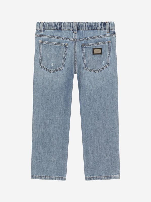 Dolce & Gabbana utilise new technological properties to create captivating aesthetics. These boys regular jeans are part of the FW24/25 Boy‚  Collection. A cool, laidback collection that boasts a ‚Äúcalligraphic-naturalistic‚Äù Majolica accent. Crafted in a 5-pocket cotton denim jeans with branded metal tag and rips. He will be obsessed. Made in Italy Denim Oversize Fit Belt Loops On Waistband Inner Waistband With Adjustable Elastic Zipper and Branded Metal Button Fastening Branded Label On Coin Pocket 100% Cotton
