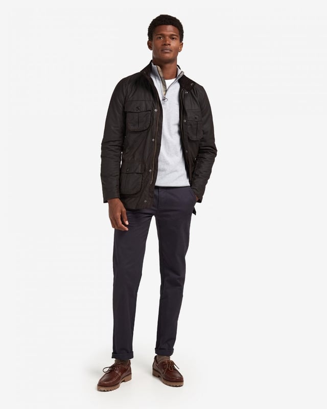 Barbour Corbridge Wax Jacket
The Corbridge is a rugged utility-style men's waxed jacket updated with a contemporary engineered fit. With winter in mind, this multi-functional jacket is constructed in Barbour's hardy 6oz Sylkoil waxed cotton with a comfortable, lightweight Nylon lining quilted to 50g wadding, for additional warmth. The corduroy-lined funnel collar features an integral Nylon hood complete with adjustable toggles for a perfect fit, offering wet-weather defence when needed but easily stowed away in the collar on dry days. Built to offer comfort and protection to those who are active outdoors in any weather, the Corbridge benefits from adjustable cuffs, a robust two-way zip, a storm fly front with stud fastenings and an action back. The classic four-pocket detail adds a stylish, practical feature that keeps essentials safe and hands free. Available in a choice of three versatile colours. As this is a slim fitting jacket, we would advise purchasing the next size up than you would normally choose.

Tailored Fit
Barbour tonal embroidery to left pocket
Outer: 100% cotton (waxed)
Inner: 100% polyamide
6oz waxed cotton
Do not wash
Sponge clean only
Back length: 78.8cm - 83cm

MWX0340