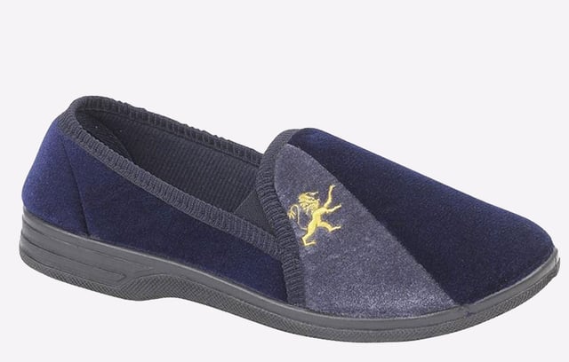 These Zedzzz men's slippers deliver comfort and style, with a sophisticated navy upper and gold detailing to the toe, complete with a relaxed slip on silhouette.- Velour upper
- Elasticated twin gussets
- Slip on silhouette
- Textile Covered Injected Sole