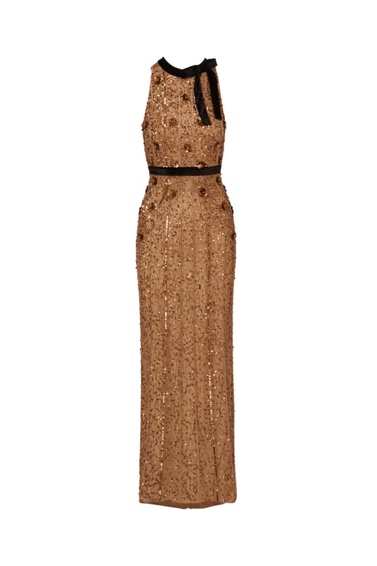 Make a bold and sparkling statement when you slip into this velvet and beaded gown. This formal dress features a halter bodice with velvet bow neckline, a velvet-trimmed waist, and a column skirt. Made with knit mesh and covered in decadent sequins and beading all over, this evening gown is trimmed with 3D sequin flowers. A hidden zipper closure at the centre back completes this column gown. A feminine look for a black-tie gala or formal attire wedding, this beaded dress will impress.