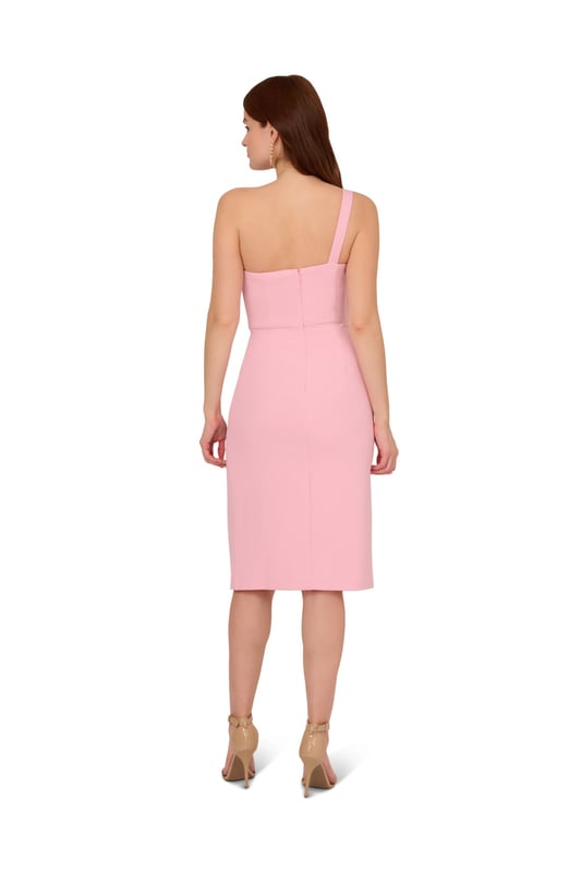 Trend-forward bow details add a fun twist to this cute short dress. This cocktail dress features a one shoulder neckline, sheath silhouette, and a bow accent at the bust with draped detailing. Designed from knit crepe fabric with some stretch, this party dress has a side slit at the skirt for easy movement. A hidden zipper closure at the side completes this one shoulder dress. Style this dress, which scales from semi-formal to formal, with nude heels and metallic accessories for a polished look.