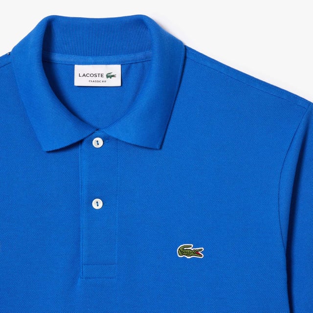 inchLacoste  inventor of the polo since 1933 Original L.12.12 Polo. Made by Lacoste. The Icon. Collar  button placket  petit piqué fabric - these are the components thought by René Lacoste. Yes  René did it first. 90 years ago  he challenged the status quo by creating the first polo to bring more freedom of movement on and off court. And put a crocodile at heart  making Lacoste the first brand who put a logo on clothing. Classic fit  comfortable ease on body and sleeves Original L.12.12 polo in our iconic petit pique renewed every season in a new large color palette. The Petit Piqué fabric is a Lacoste signature. It made of fibers knit together at two different levels of tension. The result? A finely honeycombed fabric that enables air to circulate freely. This fabric ensures comfort  ease of movement and elegance. Ribbed collar and cuffs Side slits Invisible hem Real mother of pearl buttons 3cm green crocodile at chest inch.