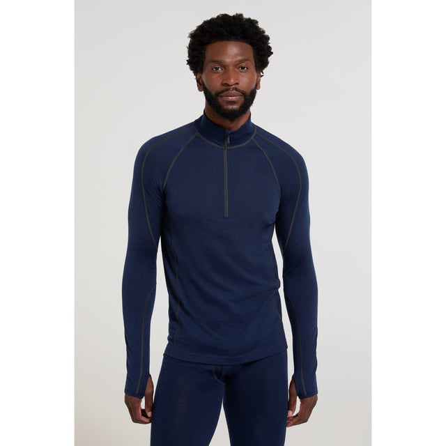 80% Merino Wool, 20% Polyester. Fabric: Performance. Design: Plain. Fastening: Half Zip. Neckline: High-Neck. Sleeve-Type: Long-Sleeved. Fabric Technology: Anti-Bacterial, Heavyweight, Thermal. Thumb Holes. XXS: 33 in. XS: 35 in. S: 37 in. M: 40 in. L: 43 in. XL: 46 in. XXL: 49 in. 3XL: 53 in. 4XL: 56 in.
