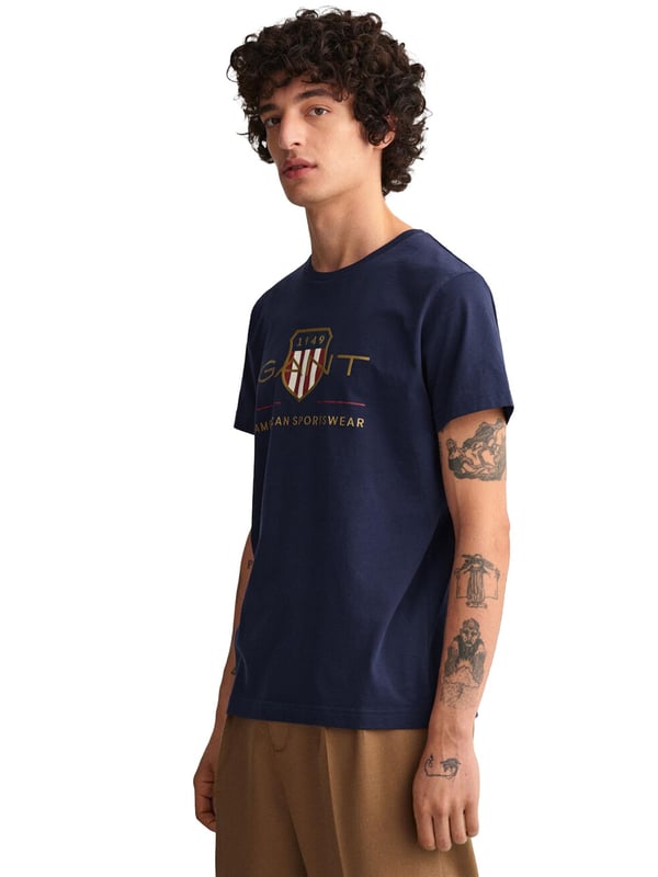 Mens Designer Gant Archive Shield T-Shirts feature Short Sleeves and a Crew Neckline. Gant Logo Printed on chest. Crafted With 100% Cotton, these Lightweight and breathable Regular Fit T-shirts are Machine Washable.