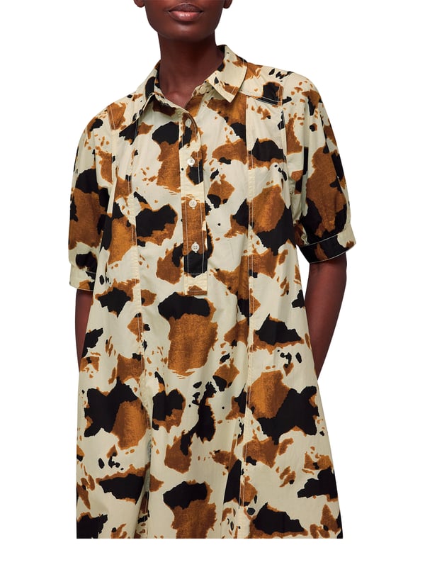Embrace the statement look with our Cow Print Midi Shirt Dress, perfect for daytime flair or a casual weekend ensemble.