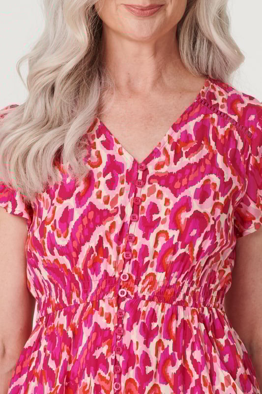Add a statement maxi dress to your closet with this vibrant printed a-line dress. With a V-neck, a button front, frilled cap sleeves, pockets and a crochet detail tiered midi skirt. Style with blush heels and a clutch bag for a garden wedding or dress down on holiday with sandals.
