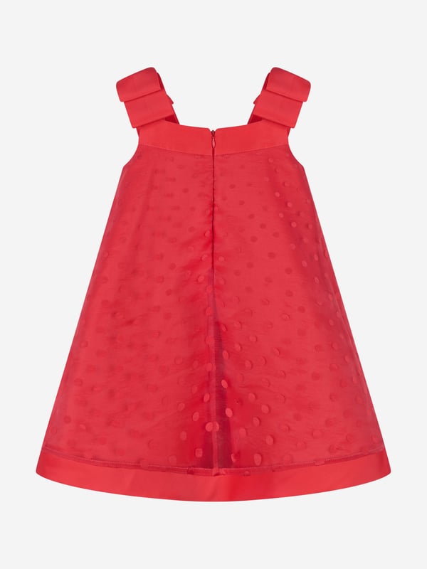 Mama Luma's sophisticated portfolio takes inspiration from a bygone era. This girls red pinafore dress is reflective of the Californian label's impeccable craftsmanship and precision of beauty. Crafted in a polka-dot chiffon pattern with red bow shoulder straps and delicate cotton lining. She will embody unparalleled confidence. Zip Fastening  70% Viscose  30% Polyester