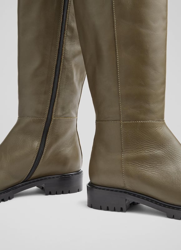 LK Bennett Lincoln Knee Boots, Army Green A knee-high boot with a biker feel, our Lincoln flat boots are a brand-new style in our autumn/winter collection. Crafted in Italy from super-soft army green calf leather, they have a round toe, a contrast border in black, an inside zip and a rugged, chunky flat sole. Wear them to dress down winter dresses or with jeans on more casual days.