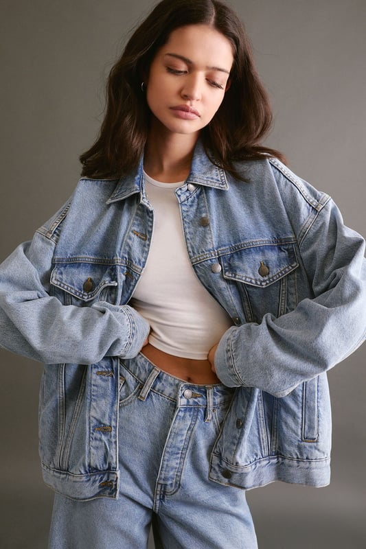 Boxy, oversized fit for a relaxed and trendy silhouette
        Classic denim construction with sturdy button-up front
        Functional chest pockets for added utility and style
        Versatile design suitable for layering over various outfits
        Timeless collar detail for a polished finish
    
    The Oversized Denim Jacket from NastyGal is a wardrobe essential that effortlessly combines comfort with style. This boxy-fit jacket offers a contemporary twist on a classic design, perfect for those seeking a relaxed yet fashionable look. The versatile nature of this piece allows for endless styling possibilities, making it a go-to choice for casual outings and laid-back events. Pair it with wide-leg trousers and chunky trainers for a trendy daytime ensemble, or throw it over a midi dress for a chic contrast at family gatherings. The jacket's roomy silhouette makes it ideal for layering over jumpers during cooler months, while its timeless appeal ensures it will remain a staple in your wardrobe for seasons to come. Whether you're heading to a casual brunch or a relaxed evening with friends, this NastyGal denim jacket will add an effortless cool to any outfit.