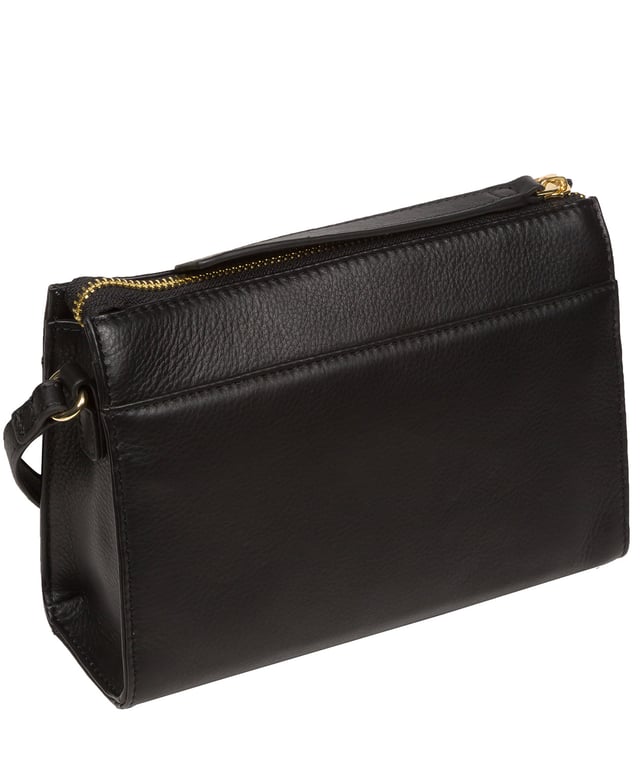 Handcrafted from Nappa leather, the 'Monica' cross body bag from the Pure Luxuries London Marylebone Collection elevates this classic design. A spacious main compartment is secured under a zip-over top which is lined with 100% cotton for a luxurious feel. Two slip pockets on the interior of the bag provide additional storage space - ideal for maintaining an organised accessory. Complementing the interior storage is a stylish pocket secured with a press-stud fastener made to look like a buckle reminscent of the classic satchel design. Gold-coloured metal fittings and zips adorn the bag alongside the slim and adjustable leather strap with a maximum drop length of 65cm. The Pure Luxuries logo is embossed in gold foil for a beautifully simple finishing touch.