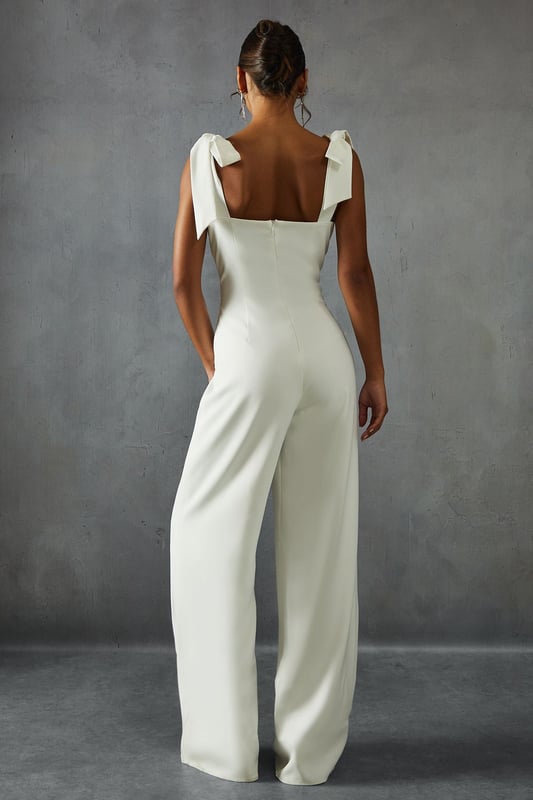 Striking bow shoulder detail for a feminine touch
        Flattering sweetheart neckline with alluring cut-out
        Wide leg silhouette for a dramatic, flowing look
        Square back design adds a modern twist
        Floor-length style perfect for formal occasions
    
    Make a statement at your next special event with this captivating wide leg jumpsuit from Misspap. The eye-catching bow shoulders lend a romantic flair, while the sweetheart neckline and subtle cut-out detail create an alluring silhouette. The wide-leg design flows gracefully to the floor, ensuring a dramatic entrance wherever you go. Style this showstopper with strappy heels and statement earrings for a red carpet-worthy look. Perfect for weddings, galas, or any occasion where you want to turn heads, this jumpsuit offers a fresh alternative to traditional evening wear. The square back adds a contemporary edge, making this piece a versatile addition to your formal wardrobe. Embrace your inner fashionista and let this jumpsuit be the centrepiece of your next unforgettable night out.
