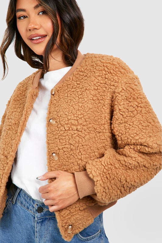 Teddy Faux Fur Bomber Jacket Keep things casual but always on-trend with a piece of outerwear perfection, the bomber jacket. A light jacket featuring a gathered, ribbed waistband and matching cuffs, a bomber jacket is versatile, timeless, and the perfect way to edge up your casual wear. Wear your new women's bomber jacket with a shirt and stripe joggers for the hottest look of the moment: sports luxe, or layer a varsity jacket over a t shirt dress for a fresh new-season look.Style: Faux Fur CoatFabric: BorgSleeve Length: Long Sleeve