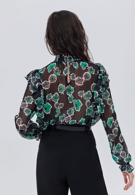 Black blouse in polyester voile for women. High collar with smocks, long elasticated sleeves. Exclusive IKKS floral maxi print. Ruffle details on front and back. Back gutter closed by buttons. Straight and fluid cut.