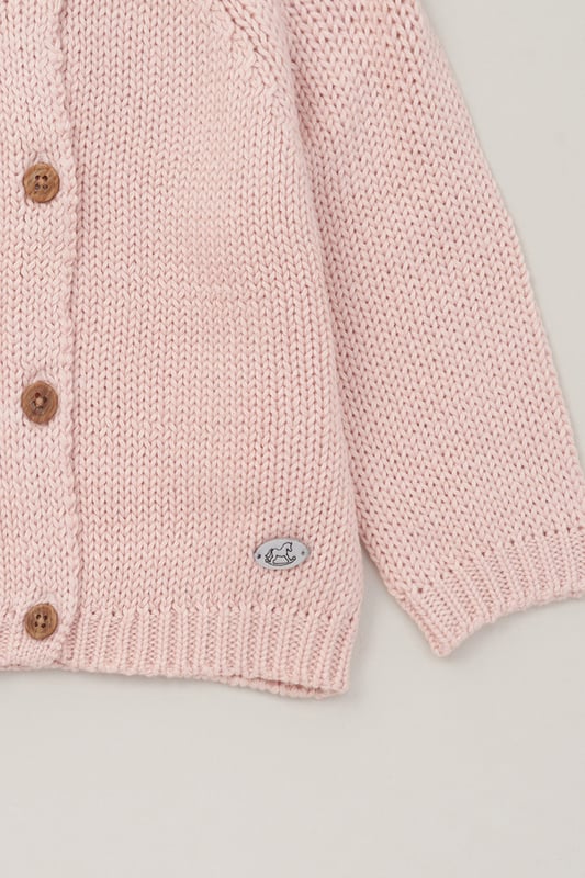 Introducing this True Knit Cardigan from Rock A Bye Baby, a wardrobe essential for your little one. Crafted from 100% cotton, this cozy cardigan features a classic button fastening for easy dressing. Plus, it's machine washable for convenient care. Keep your little one snug and stylish with this versatile must-have piece from Rock A Bye Baby Boutique.