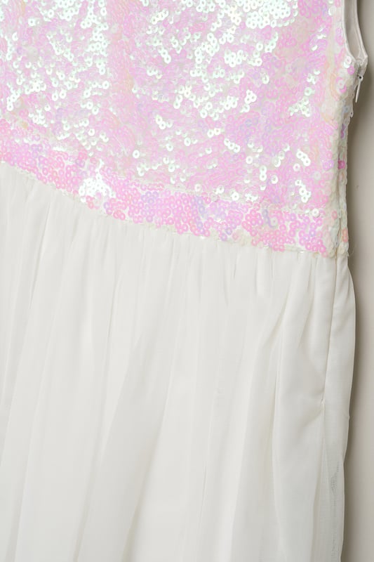 Dazzle and delight in this enchanting sequin bow dress from Luna Moon by Miss, adorned with a large bow on the back. Perfect for special occasions, this stunning ensemble exudes elegance and charm, seamlessly transitioning from shimmering sequins to a dreamy tulle skirt. Elevate your little one's style with this shimmering masterpiece, guaranteed to make a statement and capture hearts wherever she goes. Shop now for the perfect blend of sparkle and sophistication!